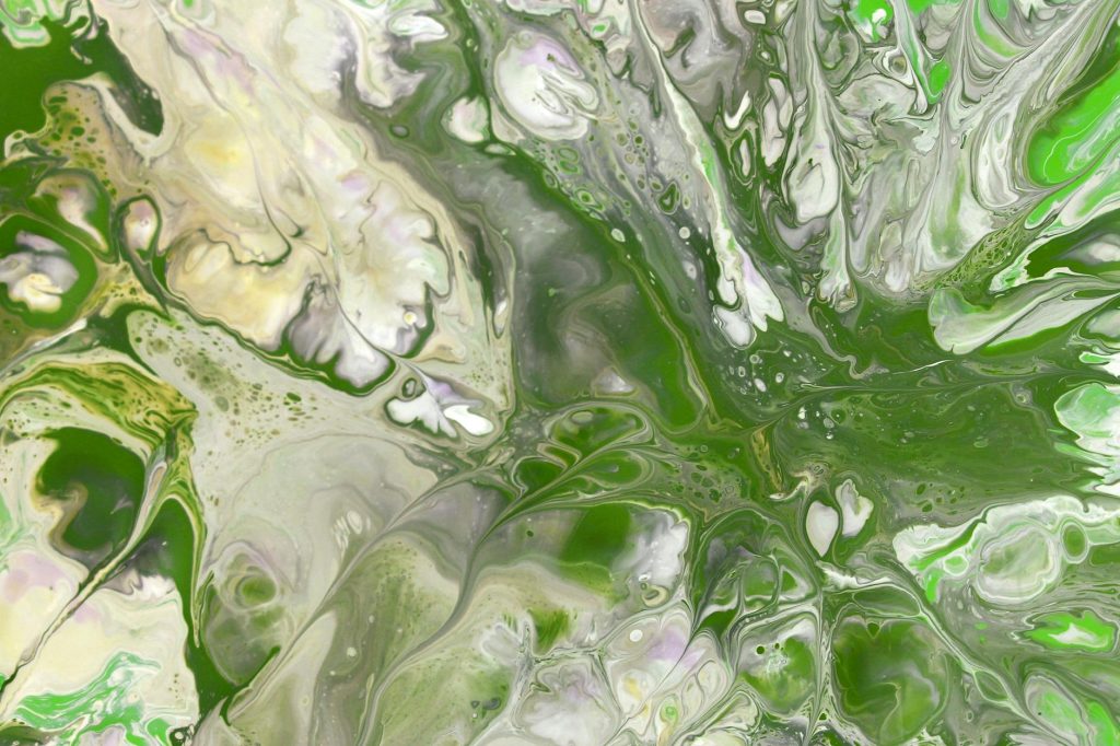 Vivid green and white marbled fluid art pattern with dynamic swirling effects.