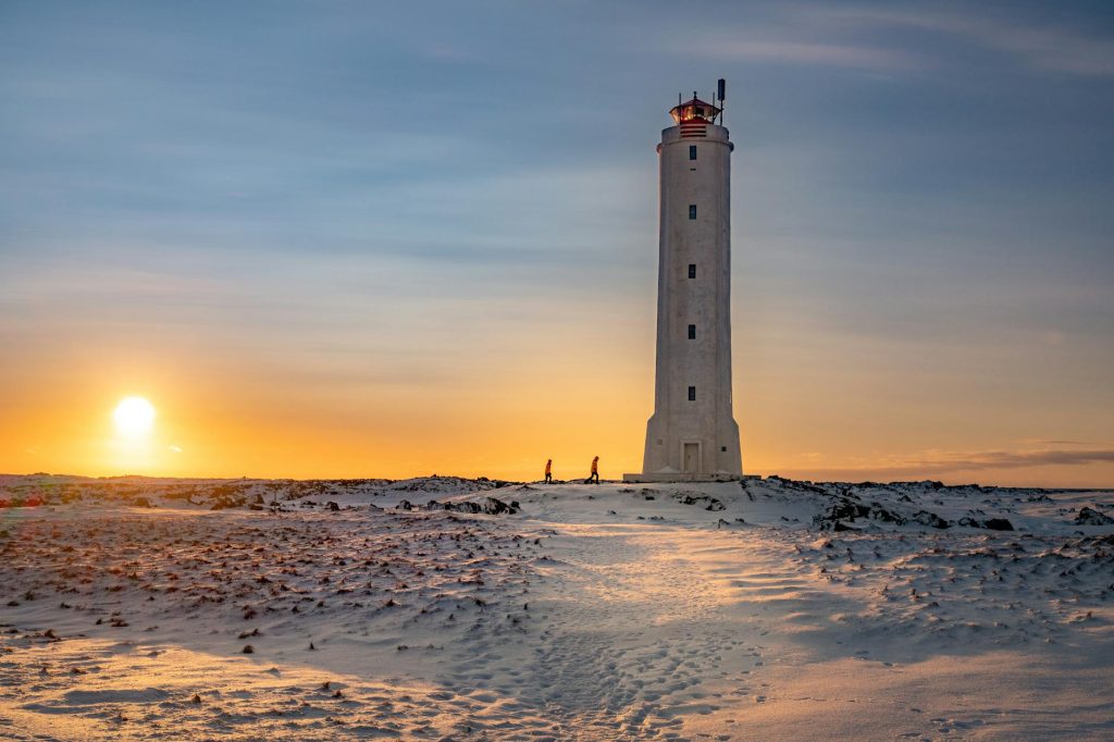 Capture of a majestic lighthouse against a winter sunset on an island. Perfect for travel enthusiasts.