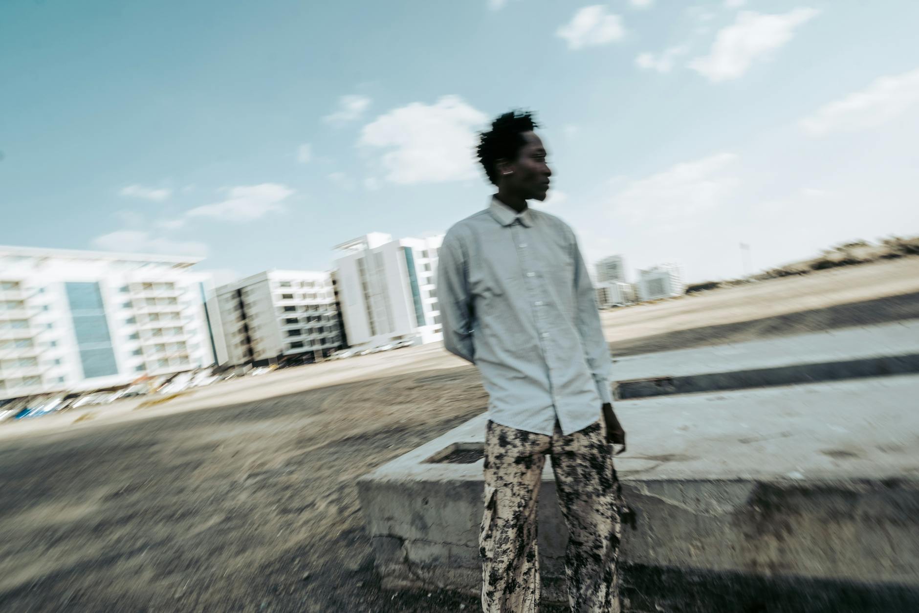 Blurred motion photo of a man in a cityscape setting creates motion and energy vibe.