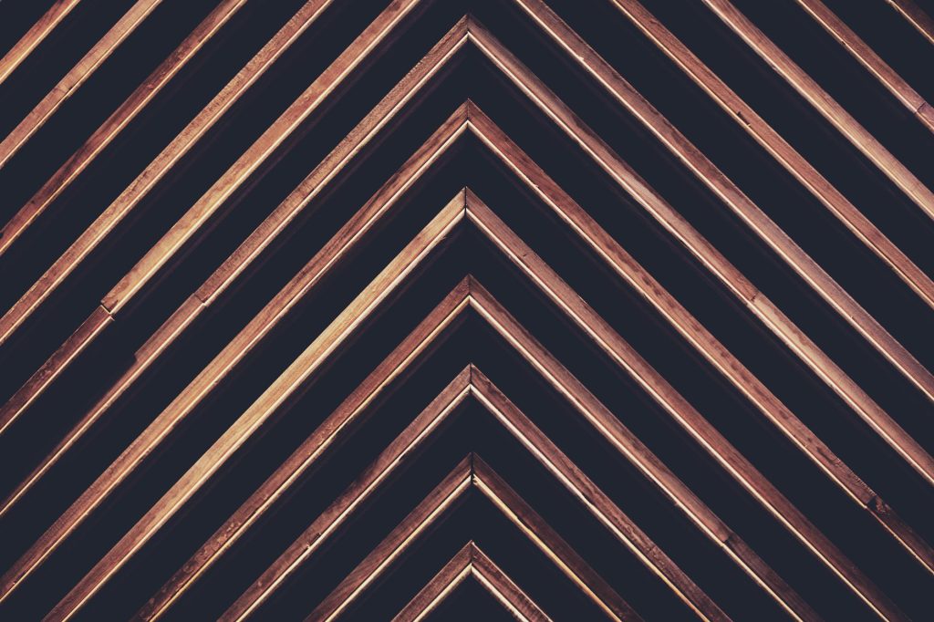 Diagonal wooden pattern with geometric shapes creating a modern abstract background.