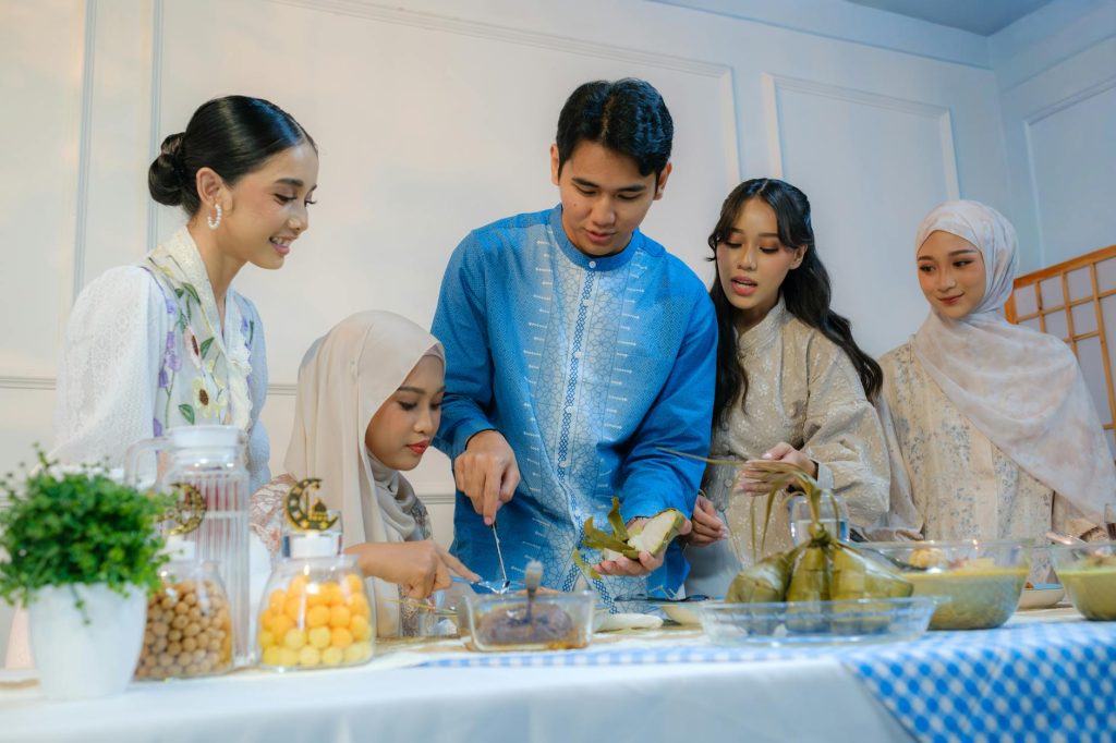 Group of friends enjoying Eid celebration with traditional dishes in Jakarta.
