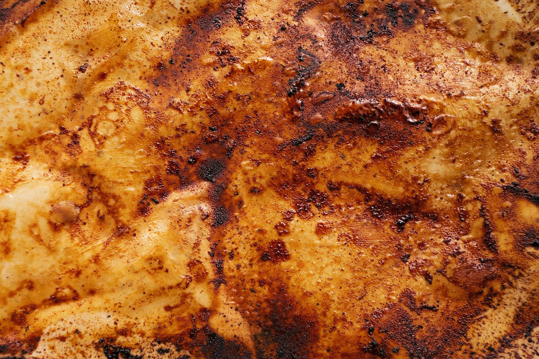 A detailed close-up of a golden brown caramelized surface texture, ideal for abstract backgrounds.